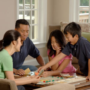 family playing board game